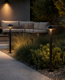 black outdoor bollard lights illuminating garden pathway at dusk