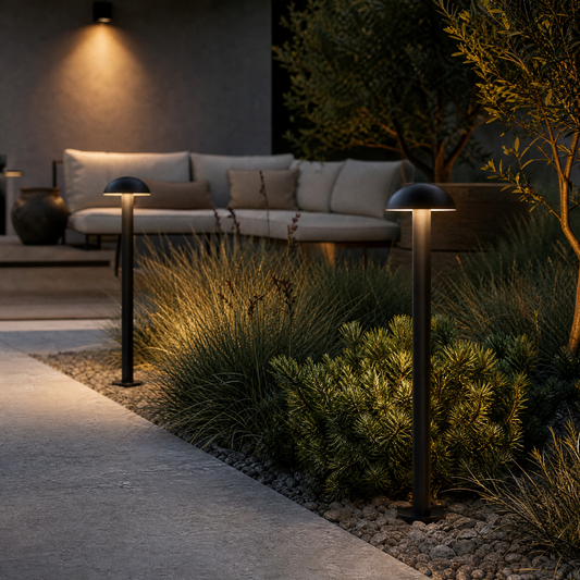 black outdoor bollard lights illuminating garden pathway at dusk