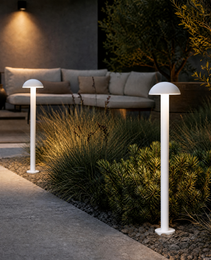 white low voltage bollards lighting concrete walkway and landscaping