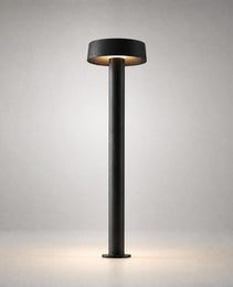 Matte black minimalist architectural ground light with flat disc shade and IP65 weatherproof rating