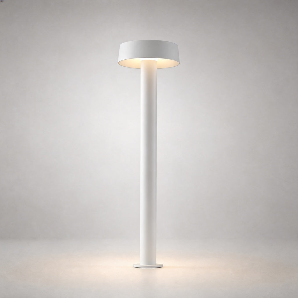 White matte cylindrical outdoor ground light with flat disc top and warm white illumination