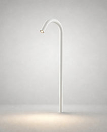 White matte ground light with arched neck emitting warm white LED in studio setting