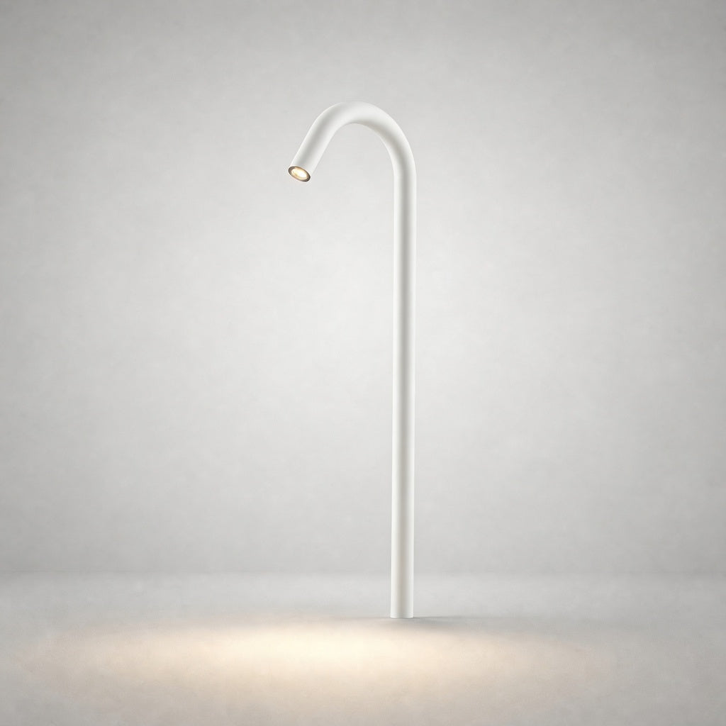 White matte ground light with arched neck emitting warm white LED in studio setting