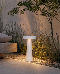 White IP67 rated LED garden light casting ambient glow beside wooden bench
