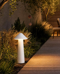 White matte cone garden stake lamp lighting wooden pathway at night