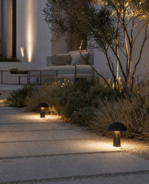 matte black mushroom path lights highlighting drought-tolerant shrubs