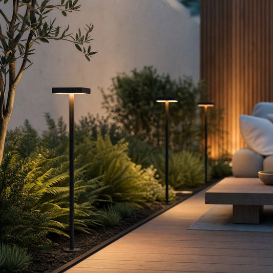 Black matte DC24V outdoor bollard light with square top illuminating garden pathway beside wooden deck
