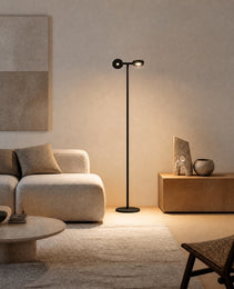 Black matte mobile projection floor lamp with dual adjustable heads casting warm sunset glow in modern living room