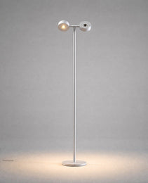 White matte mobile projection floor lamp front view highlighting dual adjustable heads and soft oval illumination pattern