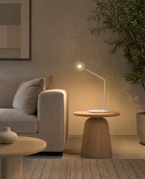 White matte projector sunset lamp on wooden table in modern interior setting