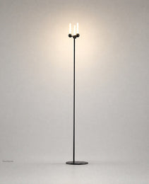 Black Mobile PRIME 0012 floor lamp with spherical joints and warm glow on gray backdrop