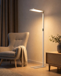 White matte floor lamp in modern living room beside beige armchair, warm white light with side control panel
