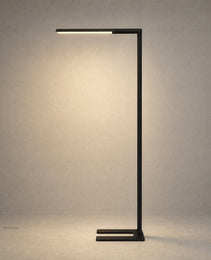 Black matte architectural floor lamp with U-shaped base and horizontal light bar isolated on beige