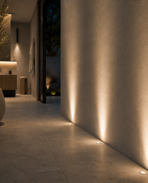 Three black GU10 MR16 floor lights illuminating textured wall in modern outdoor indoor transition