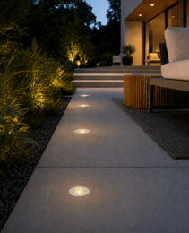 White and black DECK PRIME 1168 recessed lights lining upscale garden walkway