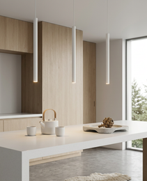 Set of three white pendant lights over kitchen island with warm glow