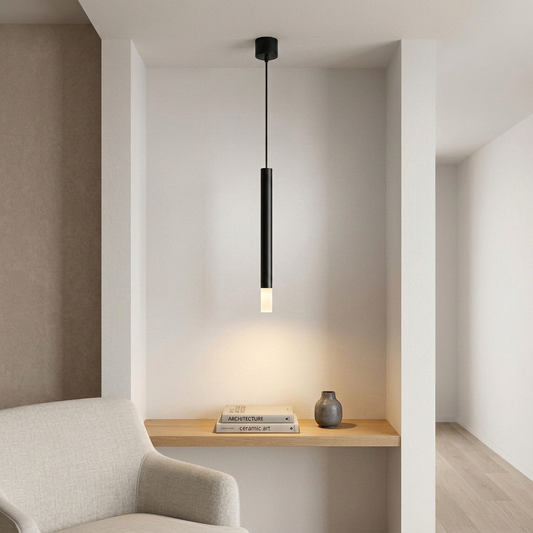 Black matte cylindrical pendant light with frosted glass diffuser illuminating architecture books in recessed niche