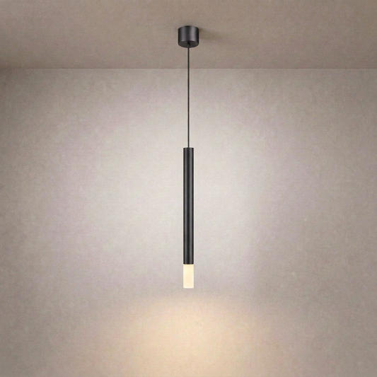 Black vertical linear ceiling suspension luminaire with matte finish casting soft glow on textured beige wall