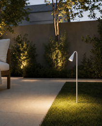 White LED garden piquet light with curved pole illuminating patio at dusk