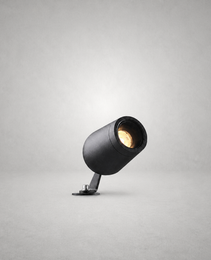 Black textured cylindrical spike lamp with silver screw fastener and warm LED light