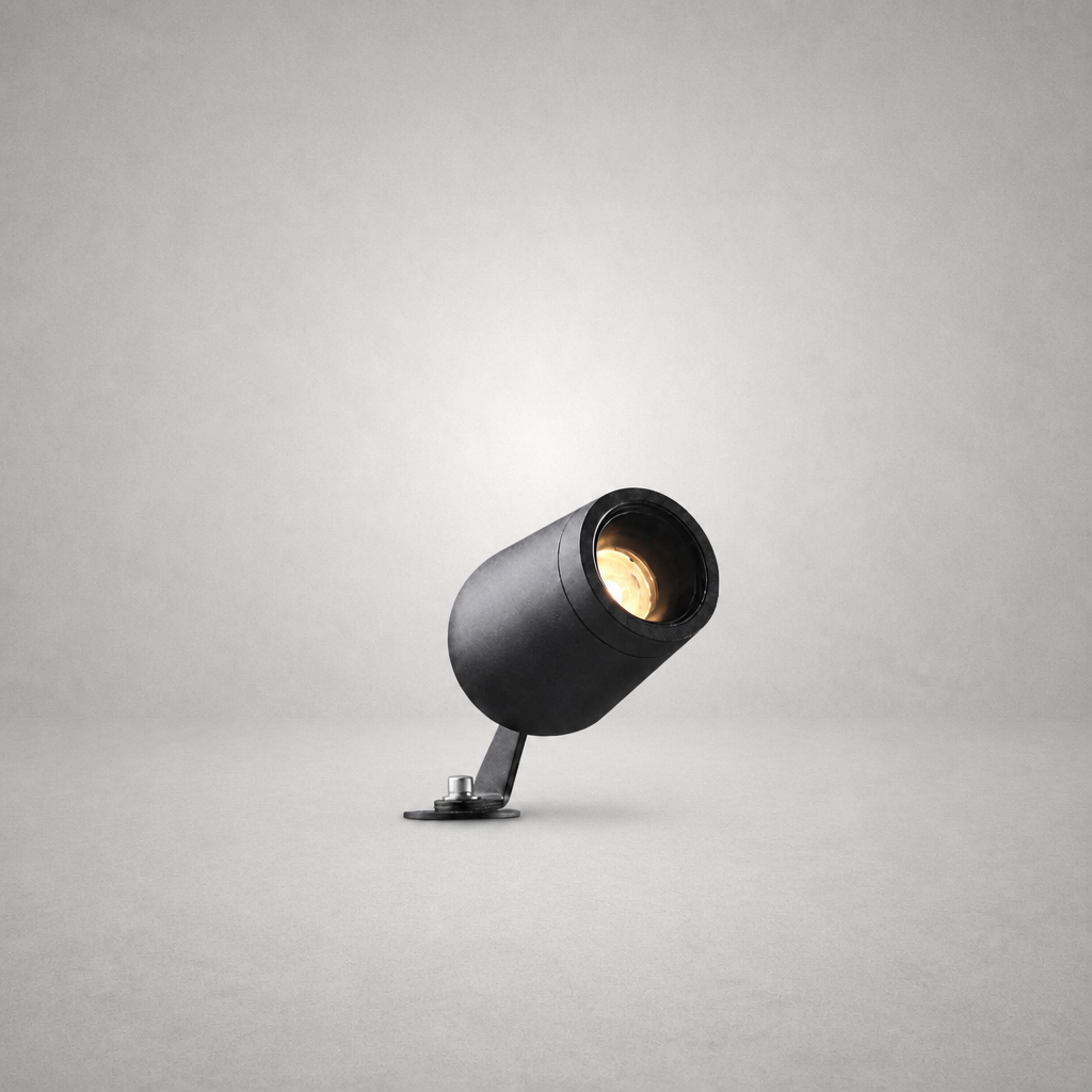 Black textured cylindrical spike lamp with silver screw fastener and warm LED light