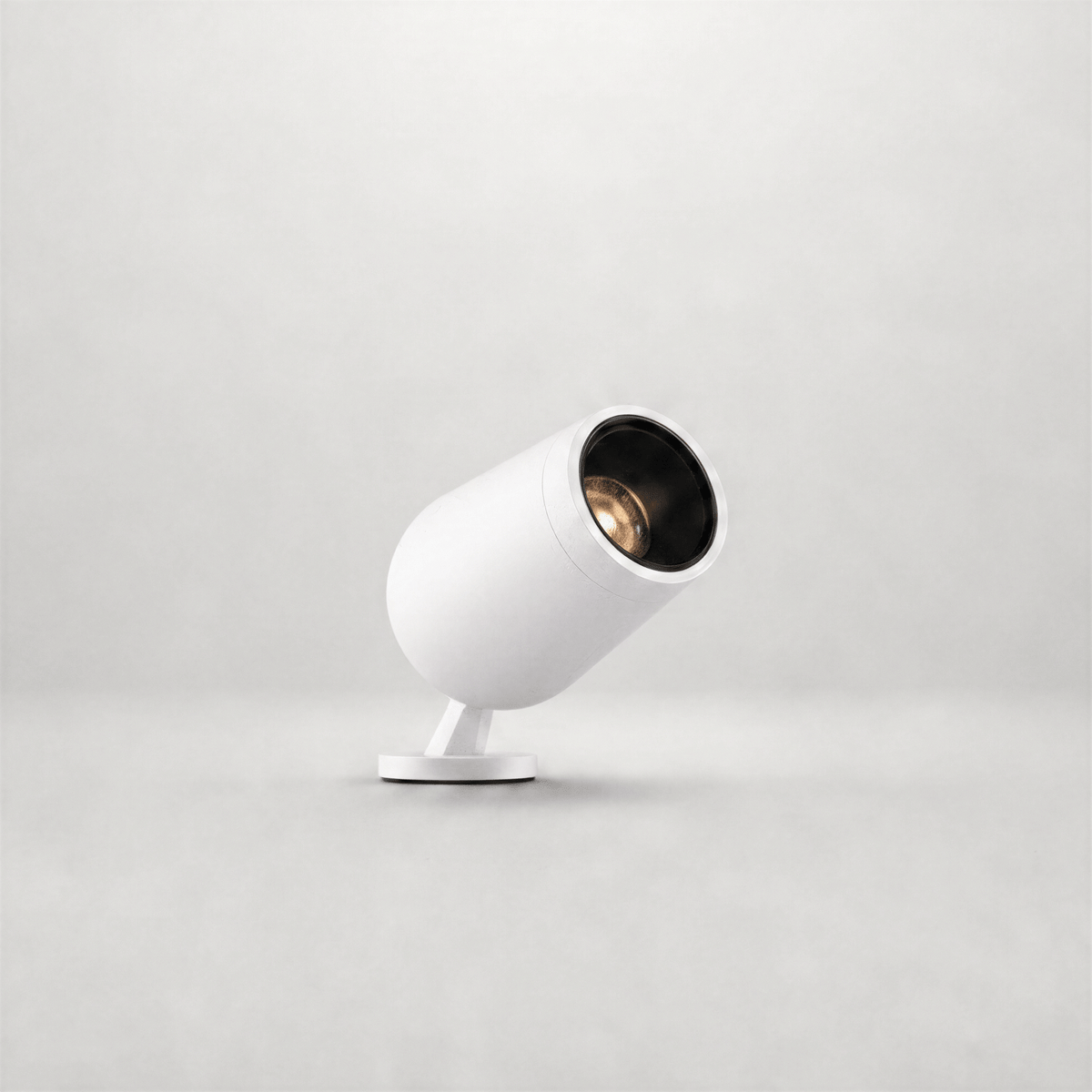 White cylindrical outdoor lamp with brushed gold interior reflector