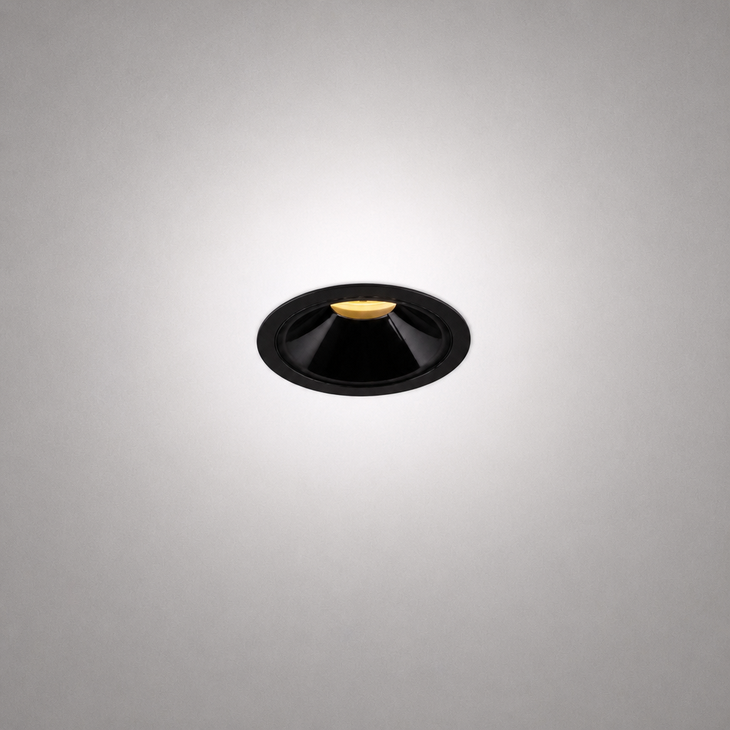 Matte black recessed ceiling light with gold LED base and conical reflector for minimalist architectural interiors