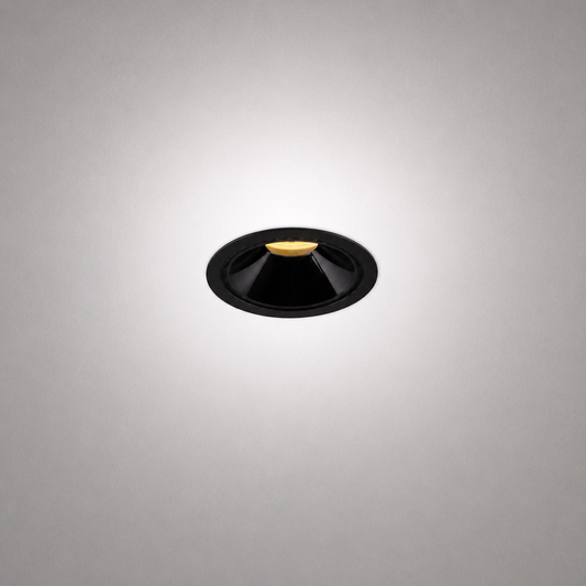 Matte black recessed ceiling light with gold LED base and conical reflector for minimalist architectural interiors