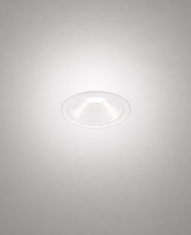 White matte trim recessed spotlight emitting warm white glow on textured gray ceiling