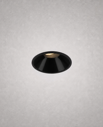 Close-up black matte finish recessed ceiling light against gray textured ceiling