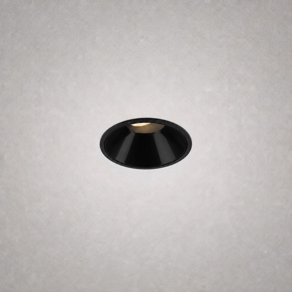 Close-up black matte finish recessed ceiling light against gray textured ceiling