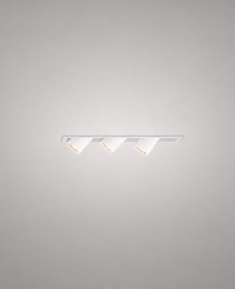 White recessed LED spotlight fixture with three adjustable heads and warm glow