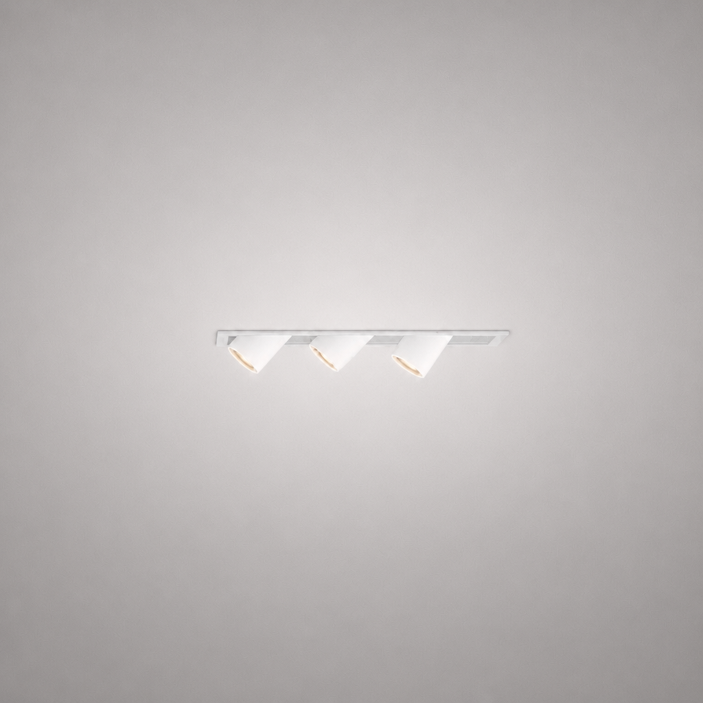 White recessed LED spotlight fixture with three adjustable heads and warm glow