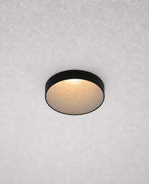 Close-up black ROYCE PRIME 1828 recessed ceiling fixture matte gold-beige reflector emitting soft warm white light