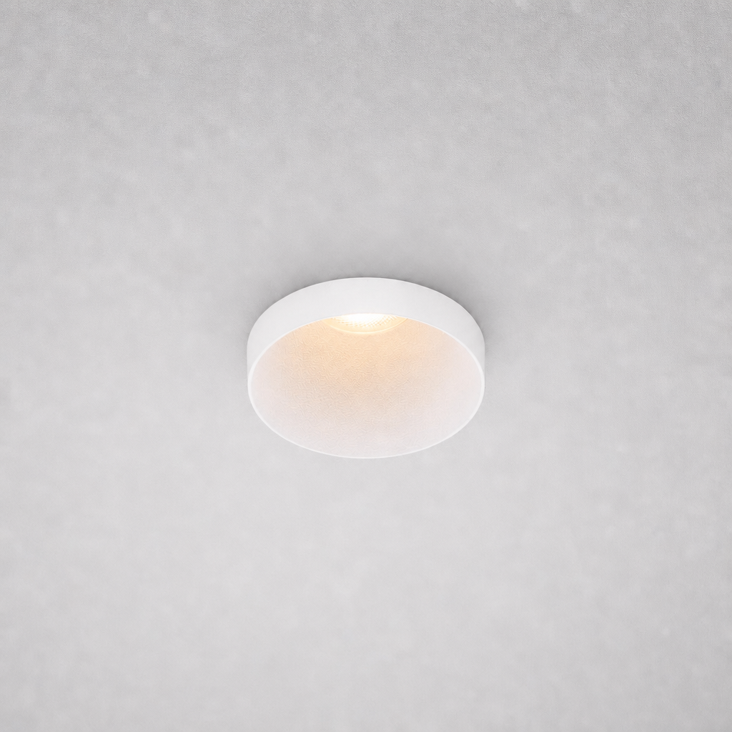 Close-up white ROYCE PRIME 1828 recessed ceiling light smooth matte finish speckled reflector for non-glare illumination