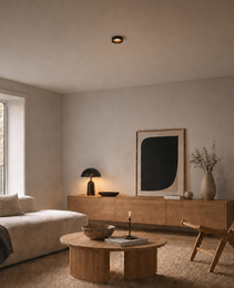 Black architectural recessed light illuminating modern living room coffee table