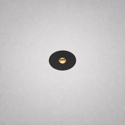 Black Vero Prime 1847 no-border recessed spotlight with gold reflector on textured ceiling
