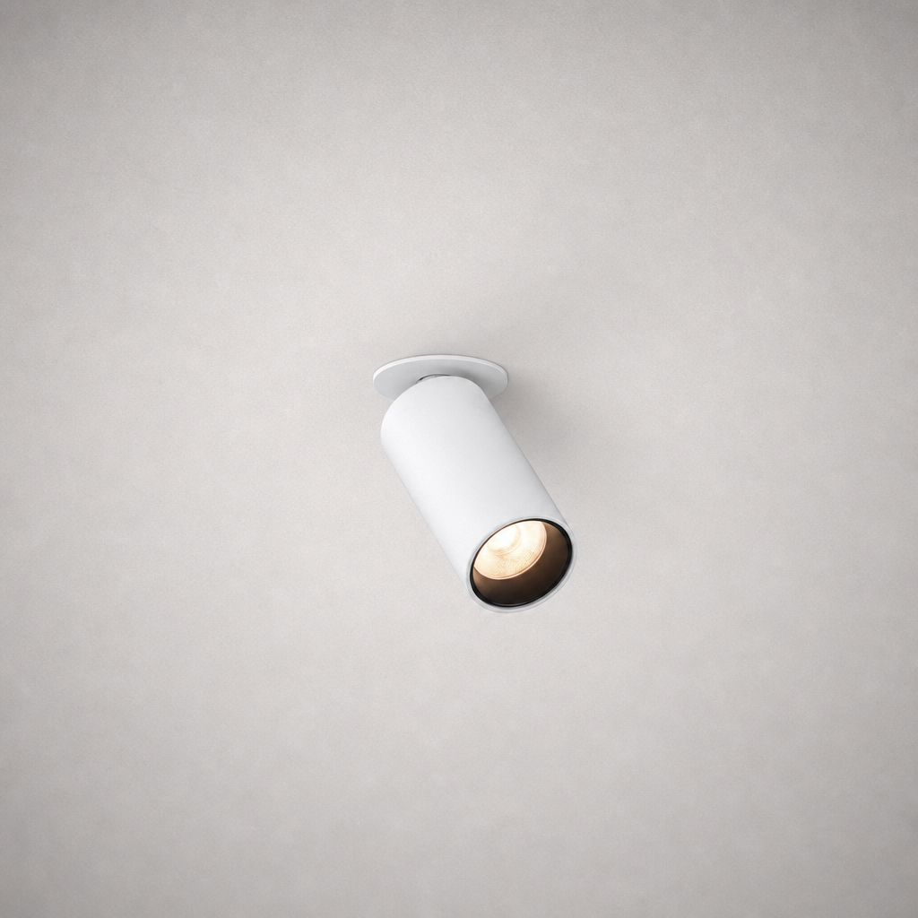 White matte finish recessed adjustable spotlight isolated on gray ceiling with warm LED glow
