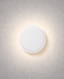 Matte white circular low voltage step light with micro-textured surface and soft halo