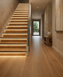 Warm white LED strip lighting integrated under wooden stair treads for seamless architectural accent