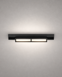 Black modern rail lighting fixture with matte finish and dual warm white modules on gray wall