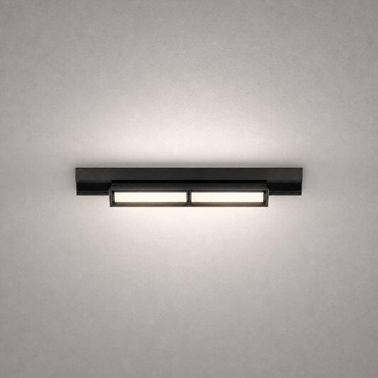 Black modern rail lighting fixture with matte finish and dual warm white modules on gray wall