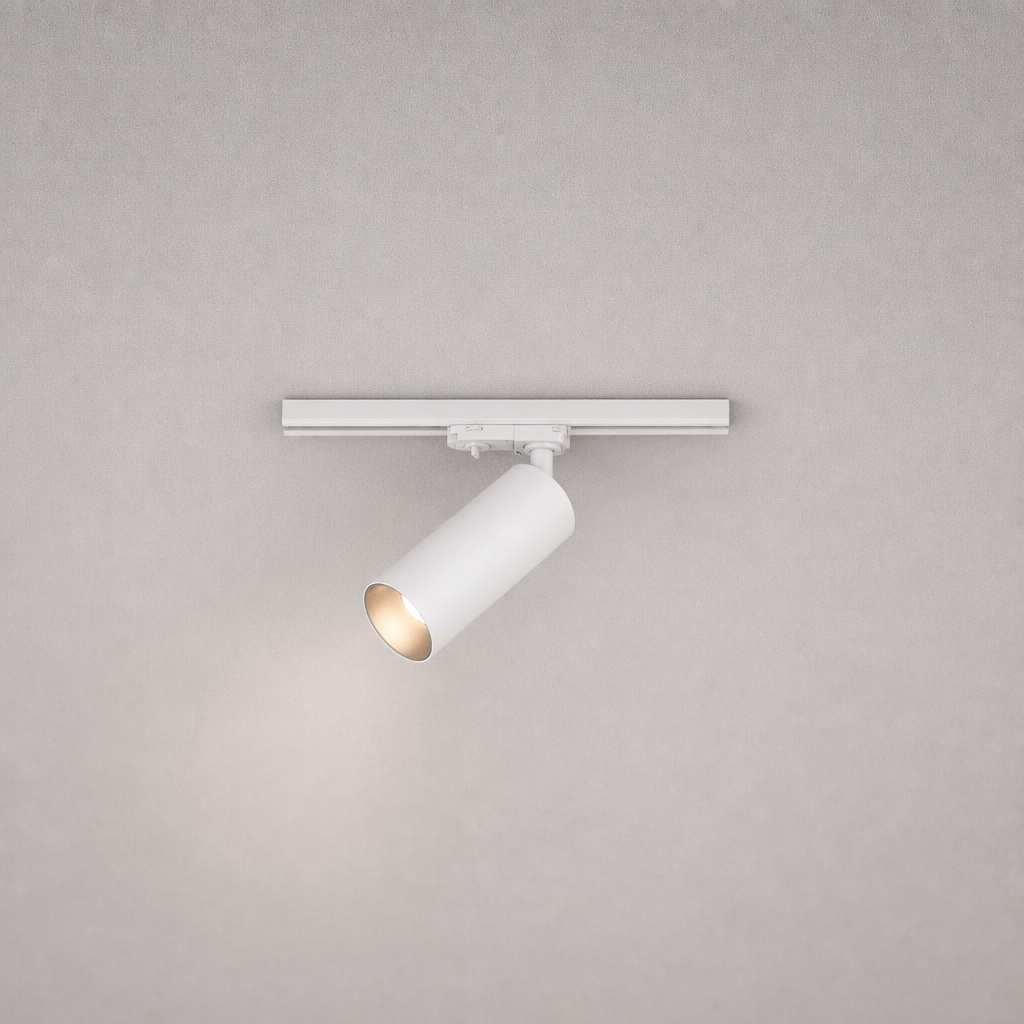 Close-up white cylindrical track spotlight with adjustable head and gold reflector