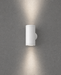 White matte finish cylindrical outdoor wall light with seamless cylinder body and integrated mounting plate on concrete