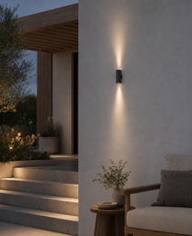 Dark gray matte outdoor wall sconce OVAL PRIME 0074 with symmetrical light beams on textured concrete
