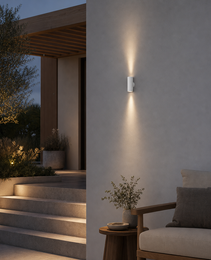 White outdoor wall lamp OVAL PRIME 0074 casting symmetrical light in evening patio setting