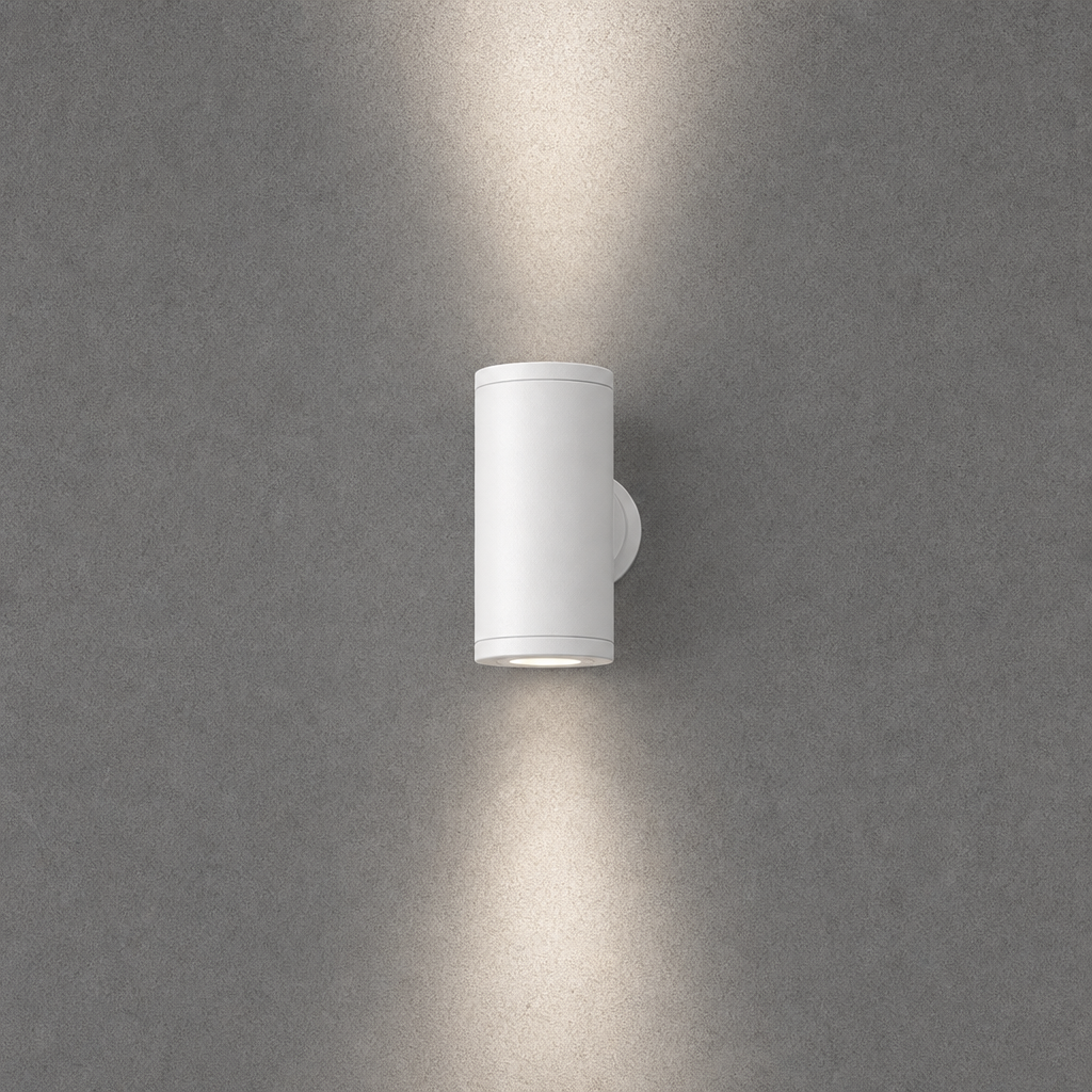 White cylindrical IP65 outdoor wall light OVAL PRIME 0074 with vertical illumination on gray concrete