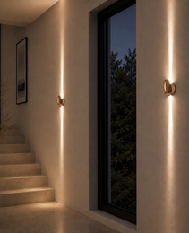 Matte gold oval architectural light fixture with symmetrical vertical beams in hallway