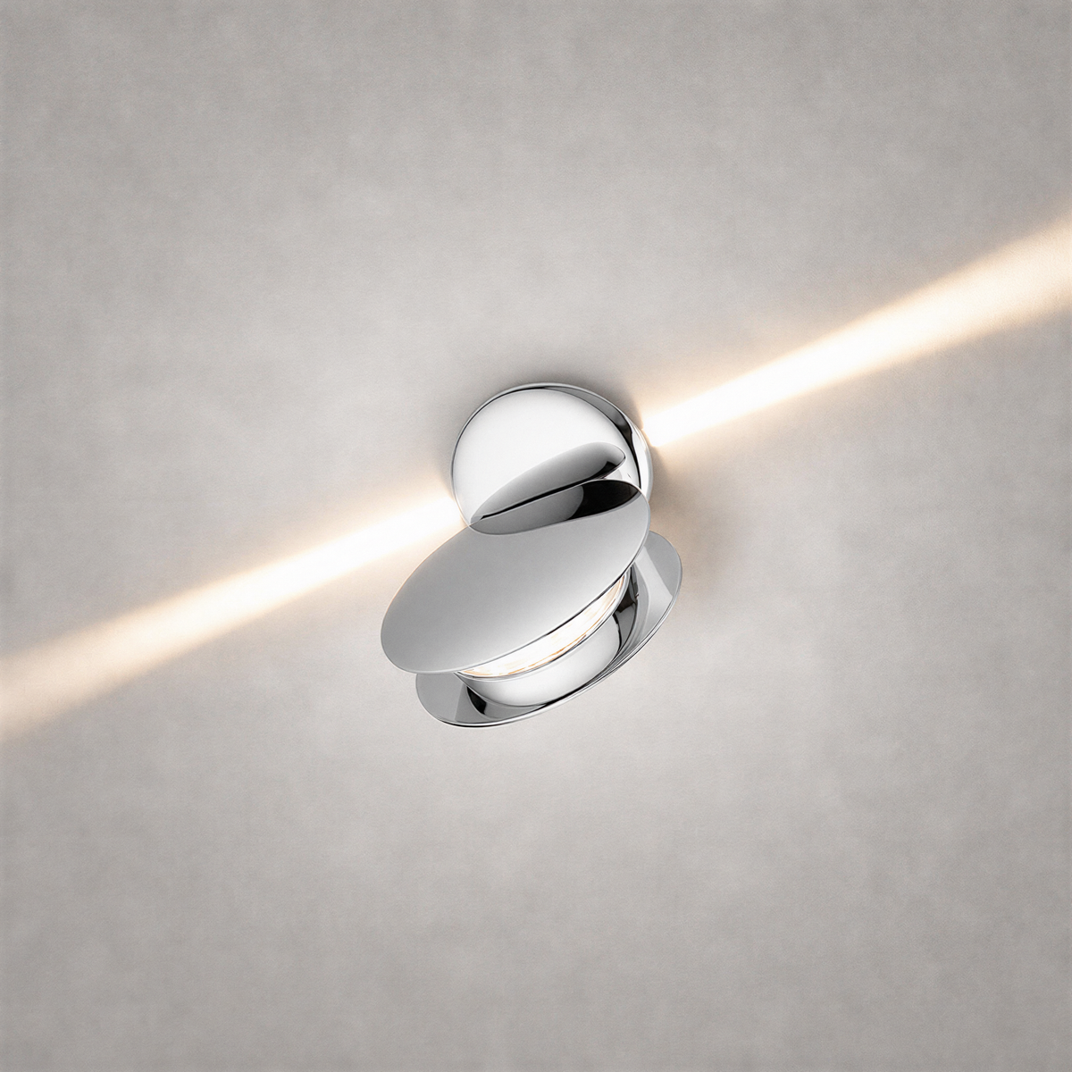 Polished chrome oval wall sconce with reflective finish and crisp diagonal light beam