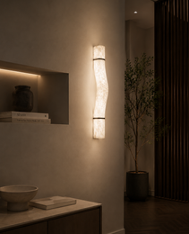 Natural alabaster wall sconce LIBRA with warm glow and visible veining mounted on textured beige wall